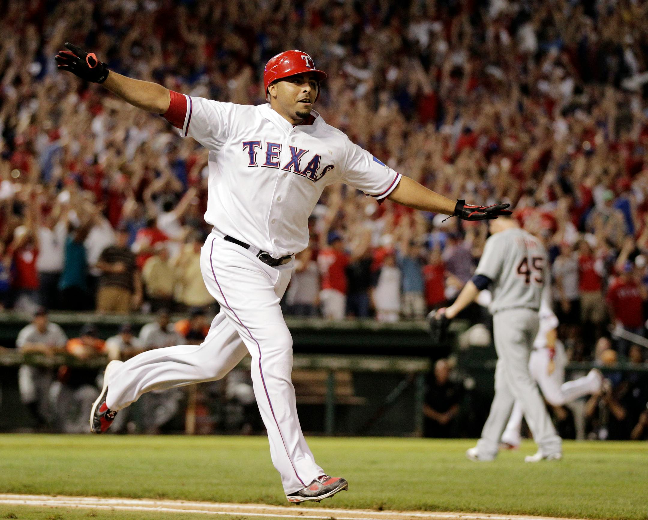 Texas Rangers' Nelson Cruz reacts after hitting a grand slam home run off of Detroit Tigers Ryan Perry, rear to win Game 2 of baseball's American League championship series 7-3, Monday, Oct. 10, 2011, in Arlington, Texas. (AP Photo/Charlie Riedel)