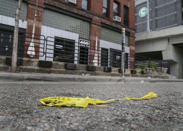 Several people were shot by a gunman early Saturday morning at 400 Soundbar in Minneapolis Saturday, Aug. 9, 2014. Here, police tape is discarded in t