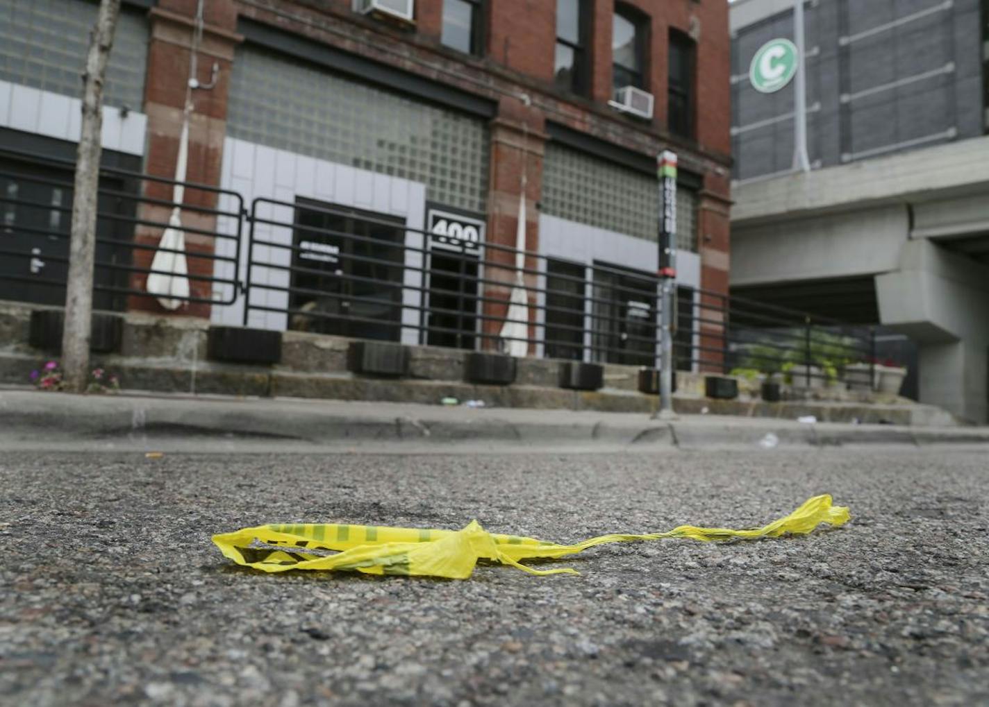 Several people were shot by a gunman early Saturday morning at 400 Soundbar in Minneapolis Saturday, Aug. 9, 2014. Here, police tape is discarded in the street, several hours after the shooting. No one is reported in custody for the shooting.