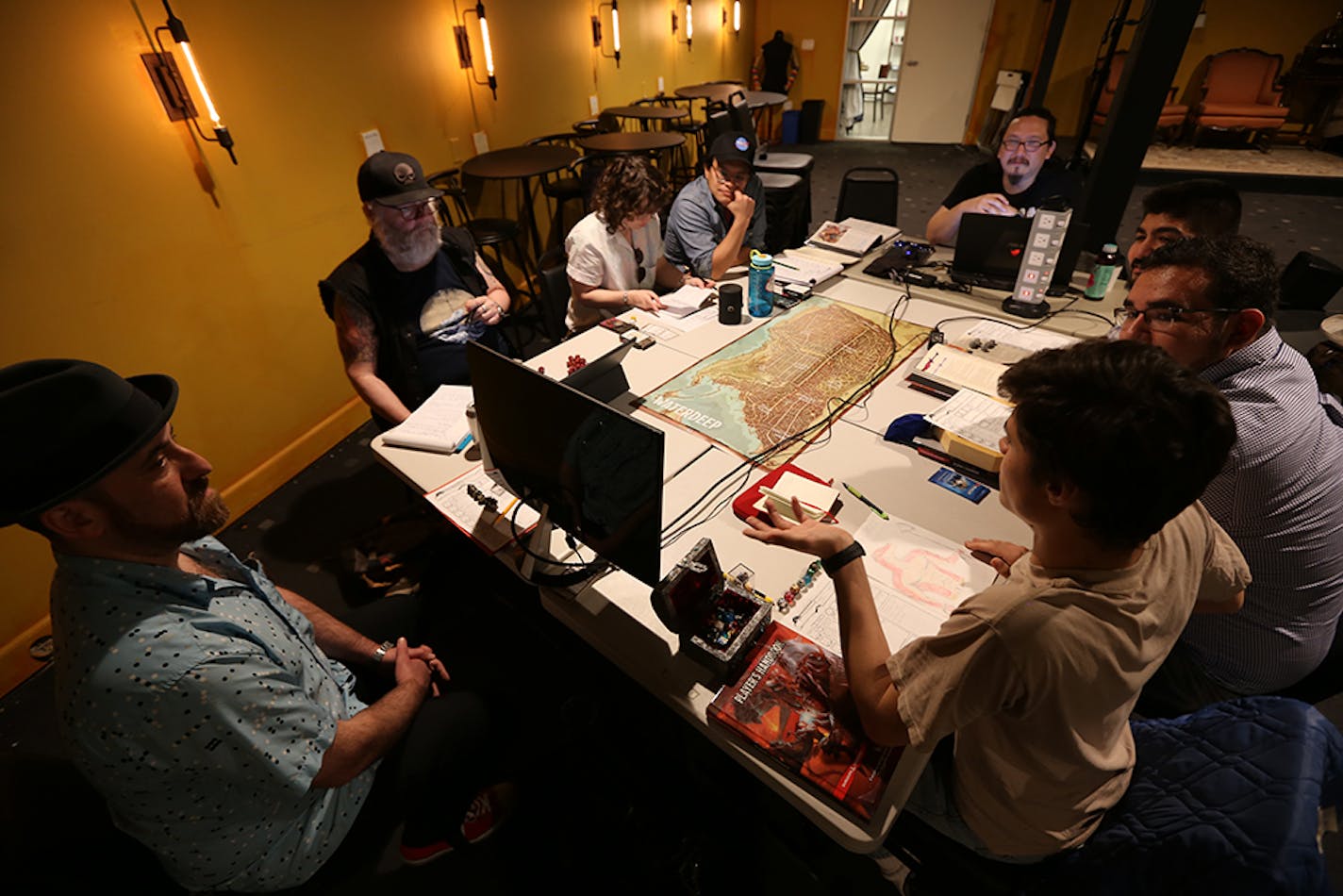 Clockwise from far left: David Wolkovich, Doug Luberts, Molly Becker, Kris Huelgas, game leader Mario Alvarenga, Carlos Ortega and Alexander Lopez play Dungeons and Dragons at Geeky Teas in Burbank, Calif.