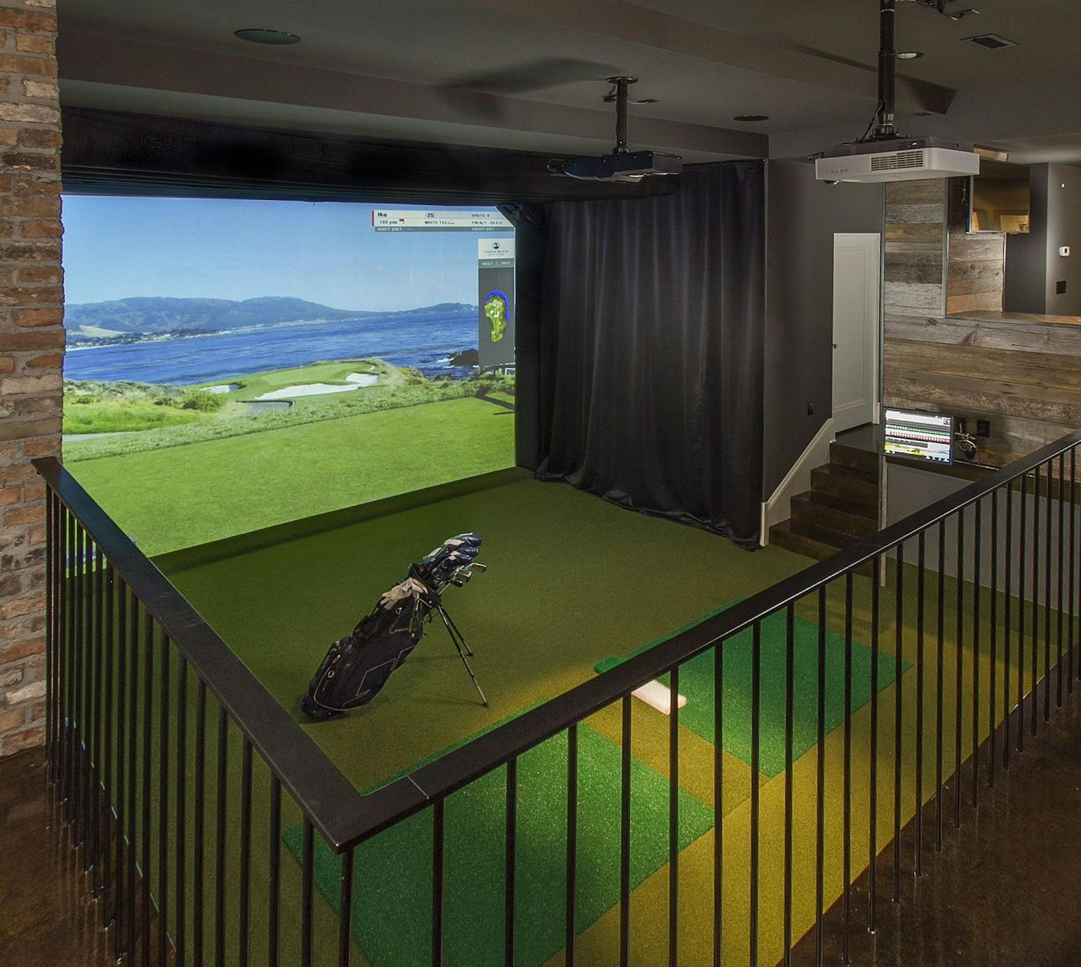 A golf simulator on the new lower level replicates 30 courses around the world. The home was remodeled by w.b. builders.