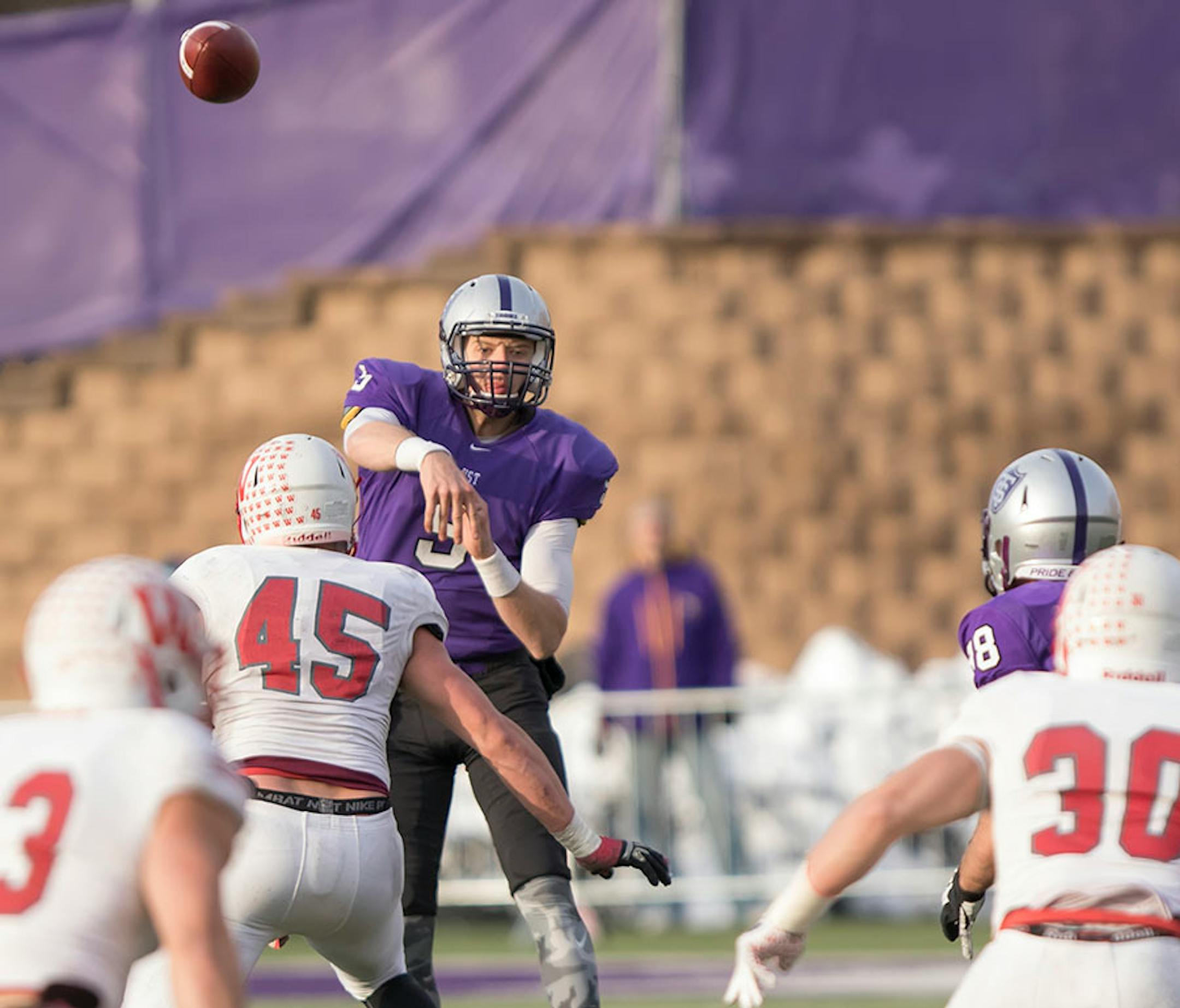 St. Thomas quarterback Alex Fenske fires a pass to St. Thomas receiver Greg Kriege (88) as the University of St. Thomas Tommies hosted the Wabash College Little Giants on December 5, 2015.