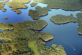 A boat navigates the waters of Namakan Lake near Kettle Falls in Voyageurs National Park.