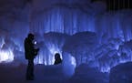 Visitors inside the Ice Castles at the Lift Bridge in Lowell Park in Stillwater.