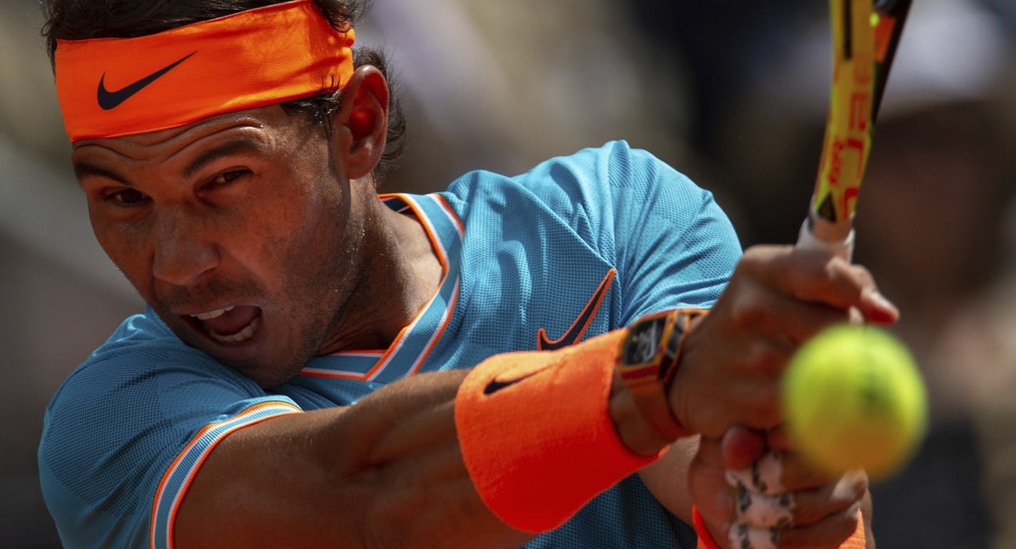 FILE - In this May 8, 2019, file photo, Rafael Nadal, from Spain, returns the ball to Felix Auger-Aliassime, from Canada, during the Madrid Open tennis tournament in Madrid. Nadal sat out the U.S. Open and has only played three matches on his favorite surface in all of 2020, hardly the sort of run-up to Roland Garros the King of Clay is used to.(AP Photo/Bernat Armangue, File)