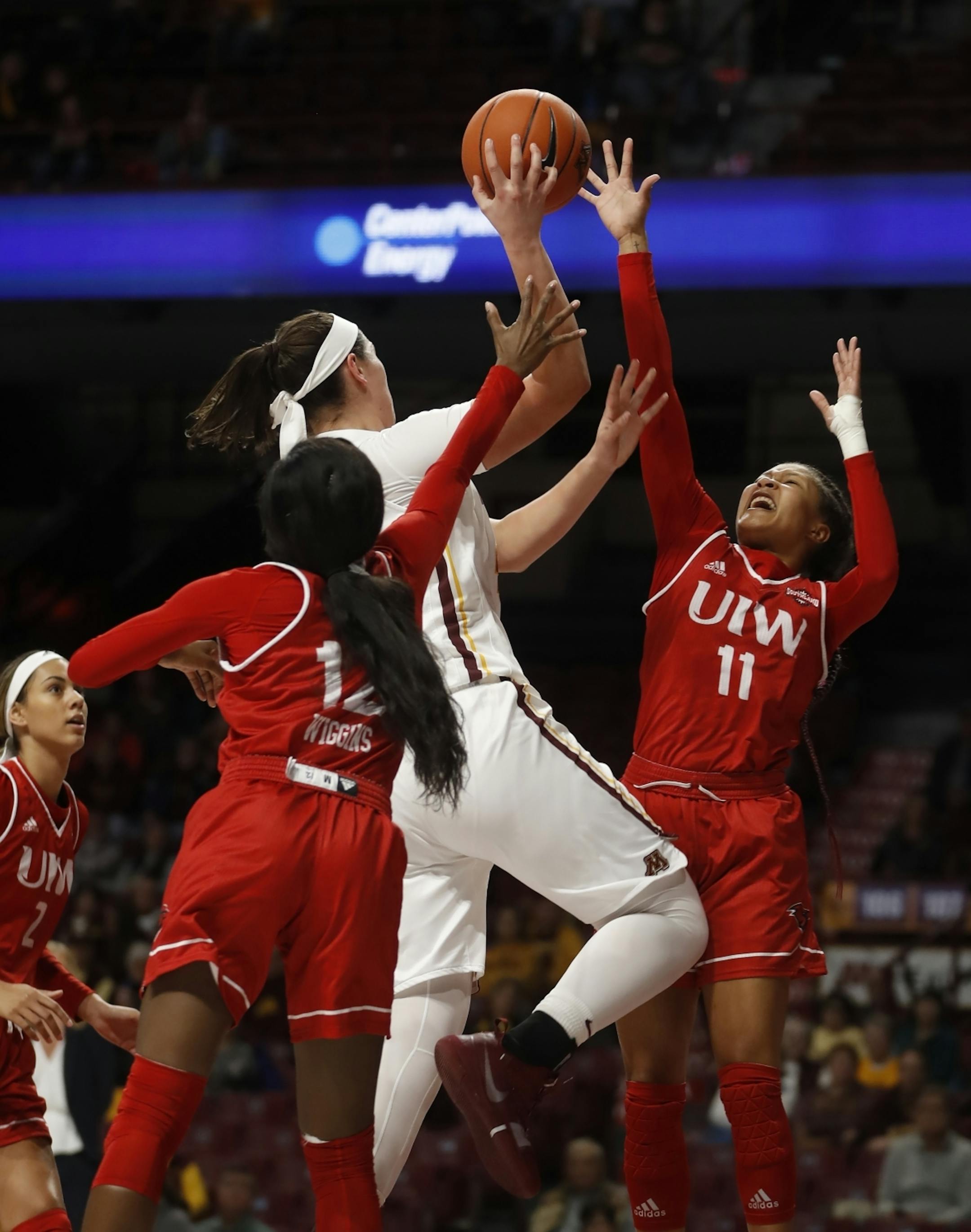Imani Robinson(11) defends against Annalese Lamke(41) of the Gophers .