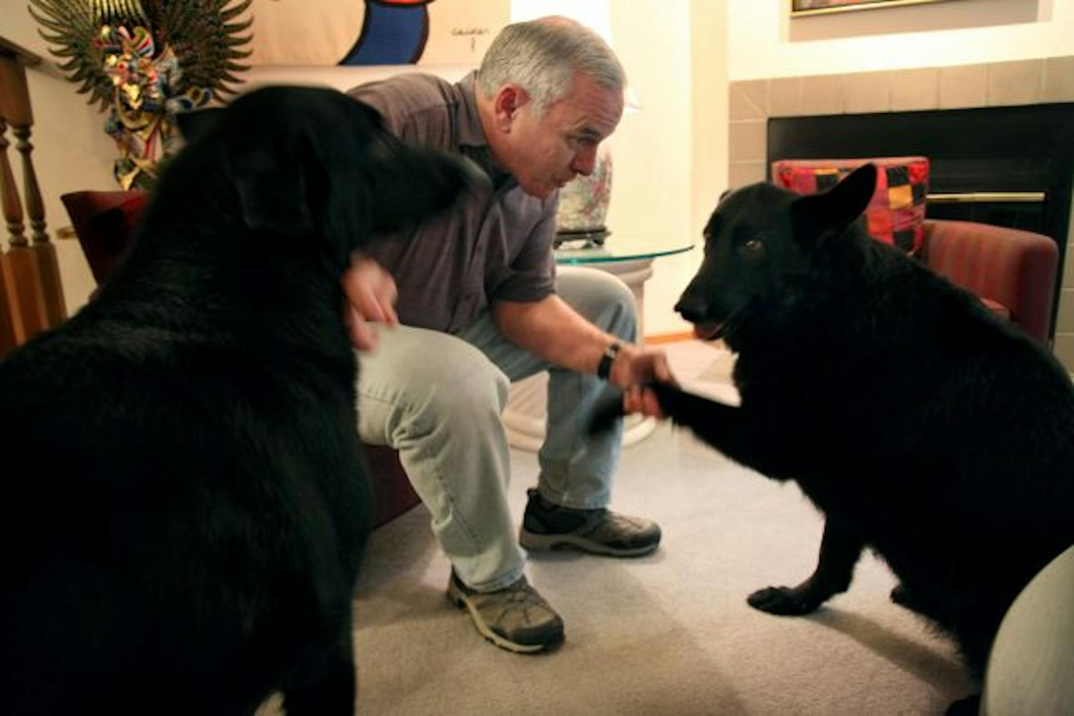 Dayton spends time with his most loyal companions, Mesabi and Dakota at his townhome in downtown Minneapolis.