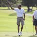 President Barack Obama tips his hat to the crowd after finishing a round of golf at Mid-Pacific Country Club during his family vacation, on Monday, De