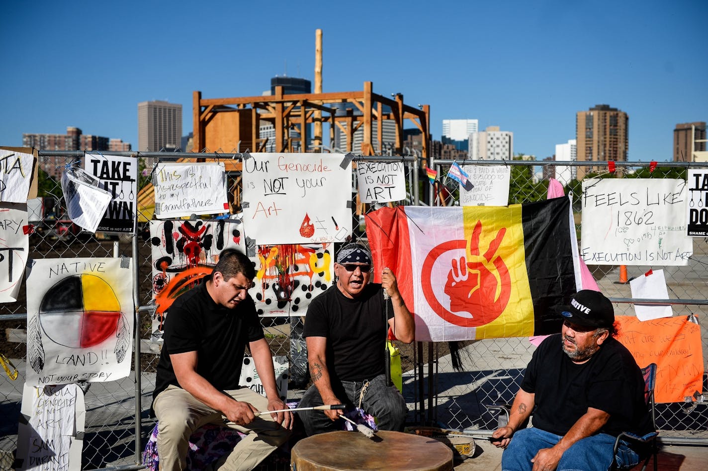 Members of the Dakota Sioux tribe held a drum ceremony Wednesday in front of the "Scaffold" sculpture by Sam Durant outside the Minneapolis Sculpture Garden. "Maybe (the spirits of) our ancestors who were hung will come if they hear this drum," said Virgil Blacklance, with the Lower Sioux, the middle drummer. To his side were Freddie LoneEagle, left, of Red Lake, and Aaron Rock, from White Earth.