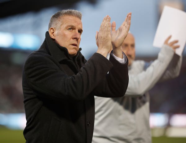 FILE - In this March 24, 2018, file photo, Sporting Kansas City's Peter Vermes acknowledges fans as he takes the pitch to lead his team against the Co