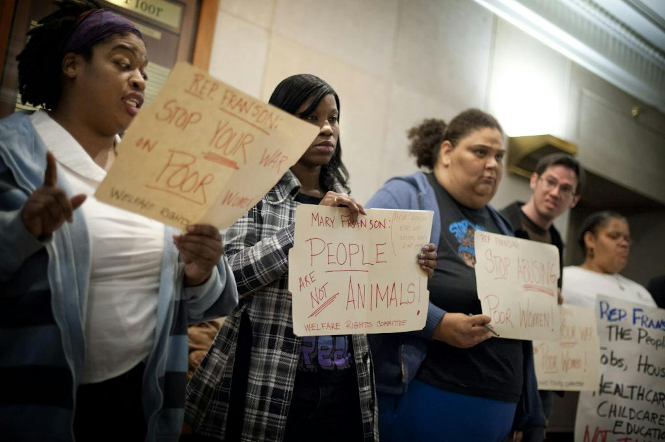 Ebony Harris, left, and other protesters called on Rep. Mary Franson to resign over comments about welfare recipients.