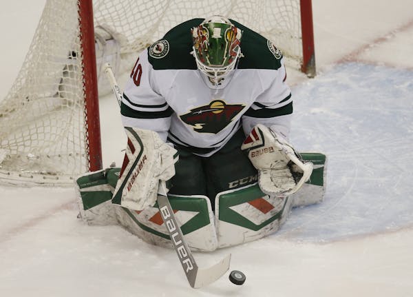 Minnesota Wild goalie Devan Dubnyk makes a save against the Colorado Avalanche in the first period of an NHL hockey game Saturday, March 26, 2016, in 