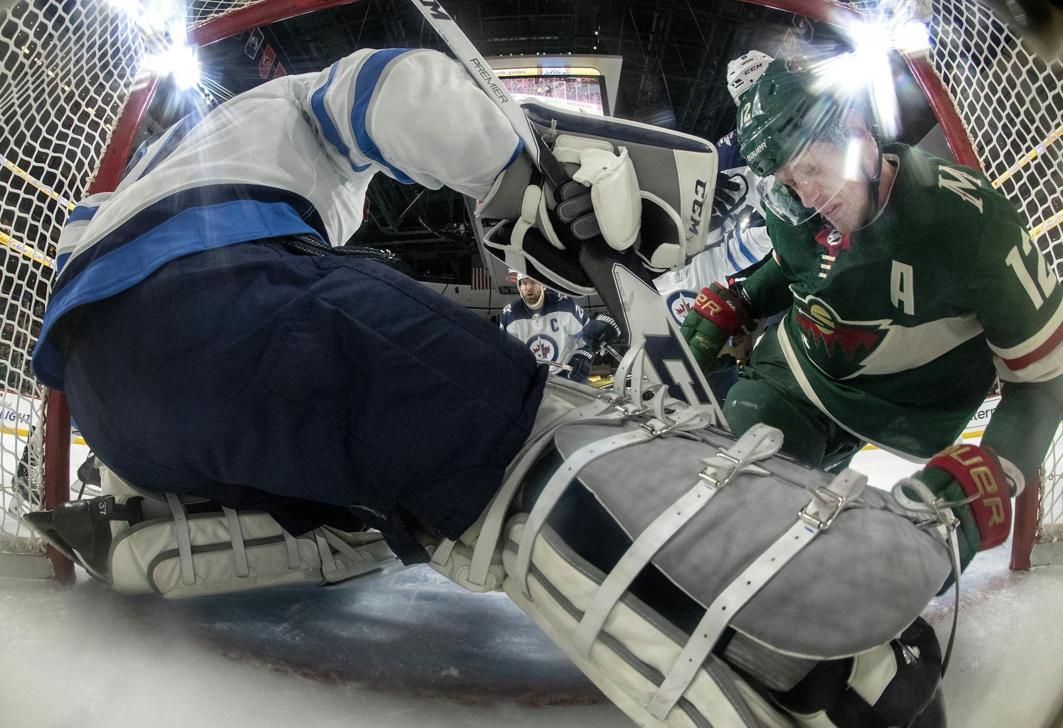 Eric Staal (12) fell into the goal in the second period.