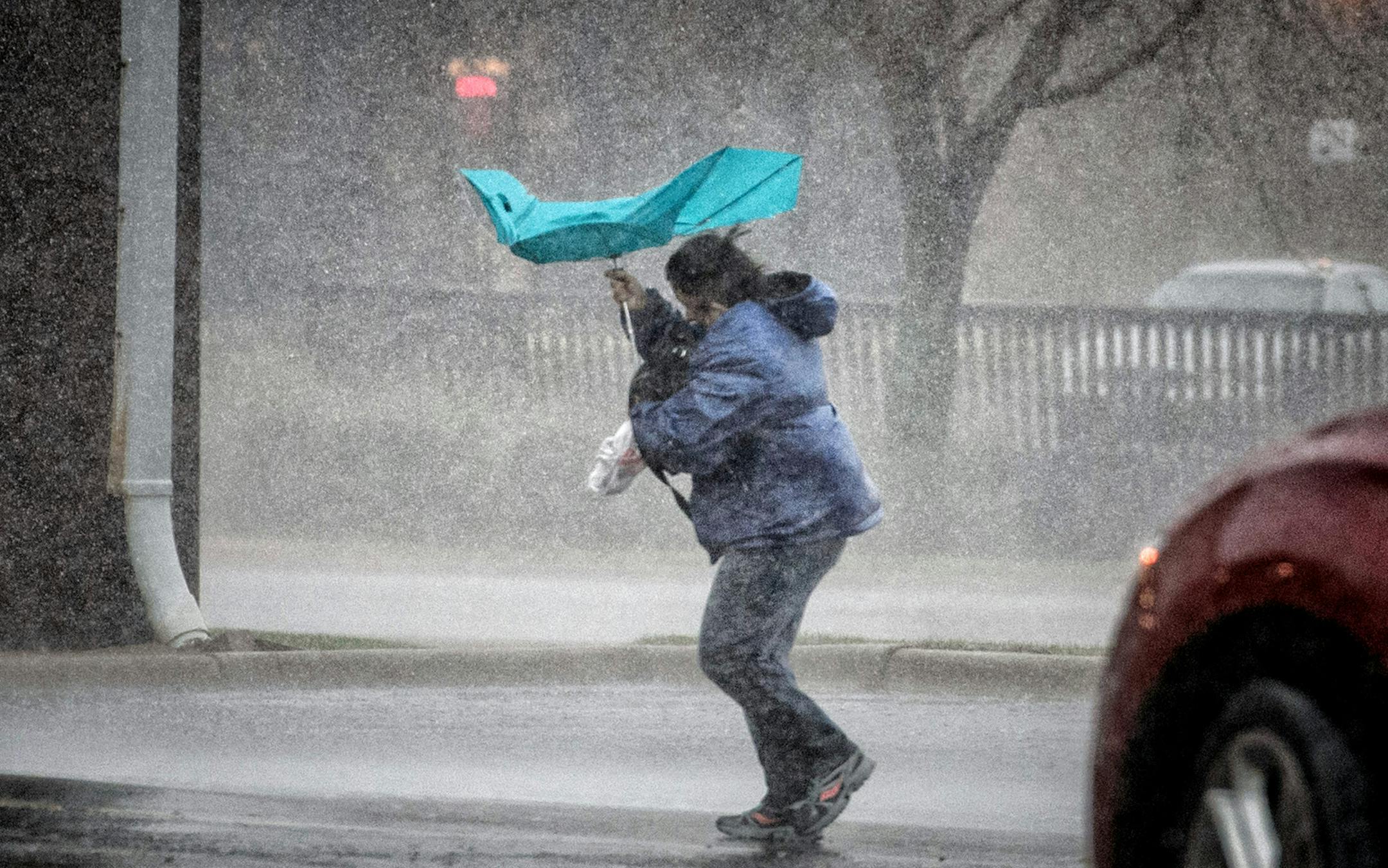 Her little blue umbrella didn't do much to protect Nou Katzmarek from an afternoon downpour in Savage, MN ] Thursday, May 8, 2014 GLEN STUBBE * gstubbe@startribune.com EDS: Reported to be his home 915 SE 8th Ave Forest Lake.