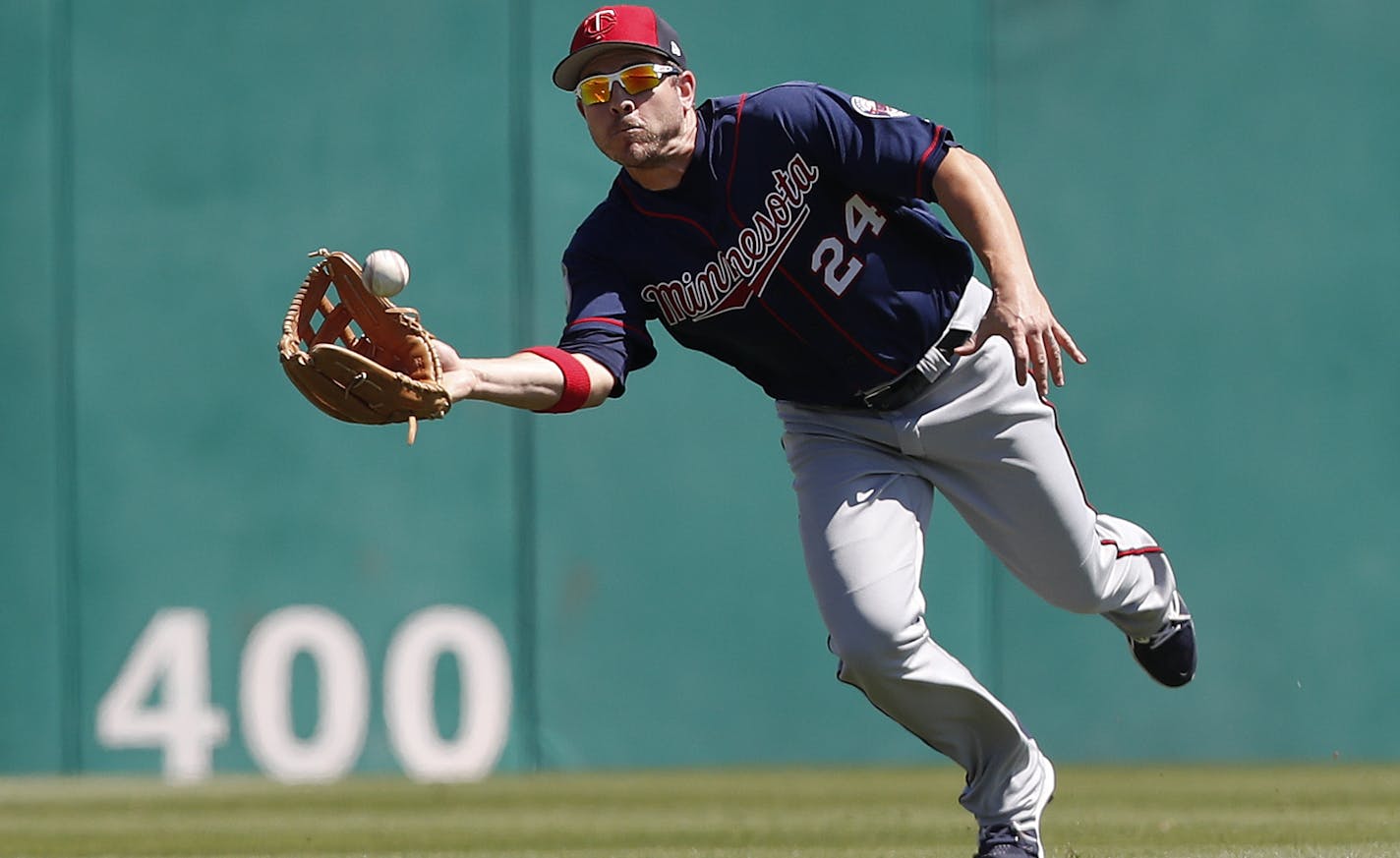 Minnesota Twins center fielder J.B. Shuck (24) makes a catch on a fly ball by St. Louis Cardinals' Kolten Wong in the first inning of a spring training baseball game Thursday, March 16, 2017, in Jupiter, Fla. (AP Photo/John Bazemore)