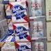FILE - Cases of beer are stacked next to each other in a Milwaukee liquor store, Nov. 8, 2018. A pair of Wisconsin wedding barns sued the state Tuesda