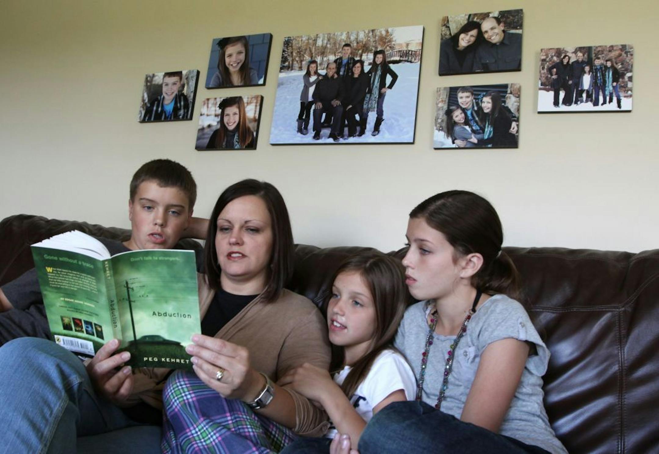 Stacy Preator of Rosemount read "Abduction" by Peg Kehret with her children, from left, Riley, 14, Sidney, 9, and Jamie, 12.
