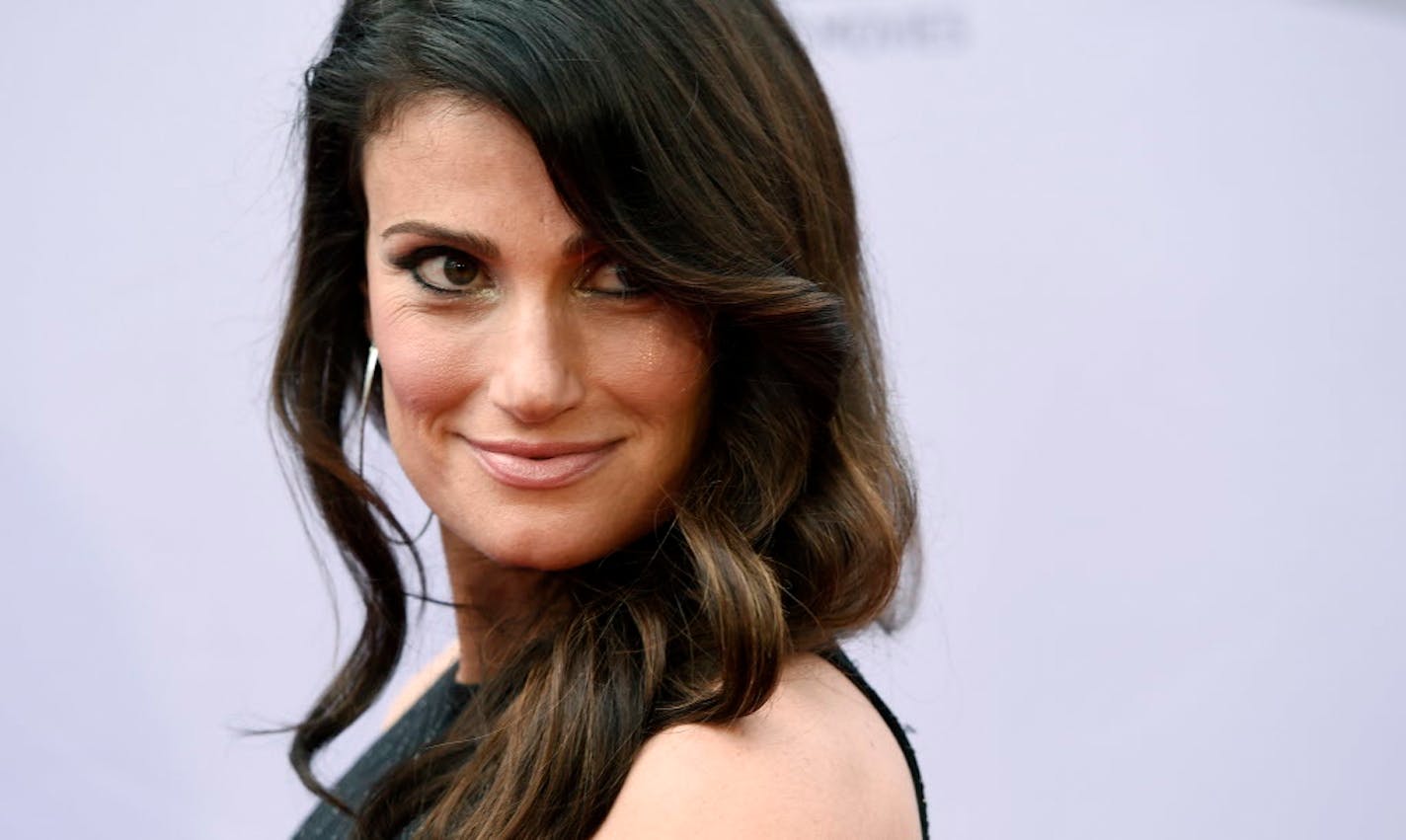 FILE - In this Thursday, June 9, 2016, file photo, singer Idina Menzel looks over her shoulder at photographers at the 2016 AFI Life Achievement Award Gala Tribute to John Williams at the Dolby Theatre in Los Angeles.