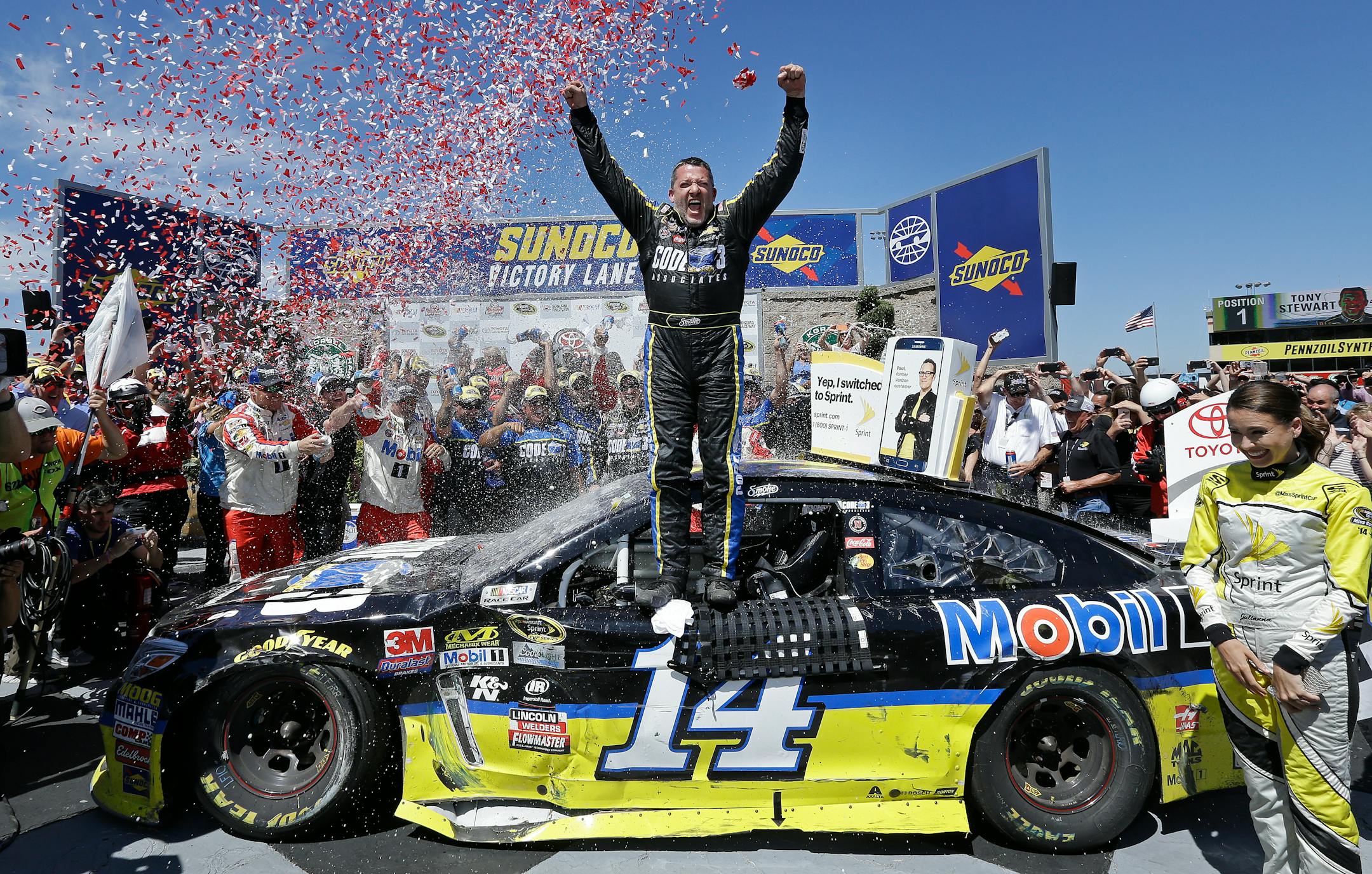 Tony Stewart, center, celebrated after winning the NASCAR Sprint Cup Series auto race Sunday, June 26, 2016, in Sonoma, Calif.