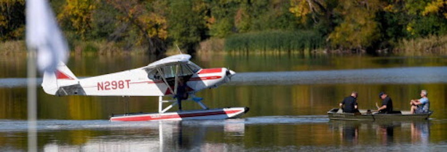 CHASKA, MN - OCTOBER 02: Police pick up an occupant of a sea plane landed near the seventh green during singles matches of the 2016 Ryder Cup at Hazeltine National Golf Club on October 2, 2016 in Chaska, Minnesota. (Photo by Ross Kinnaird/Getty Images) ORG XMIT: 672195567