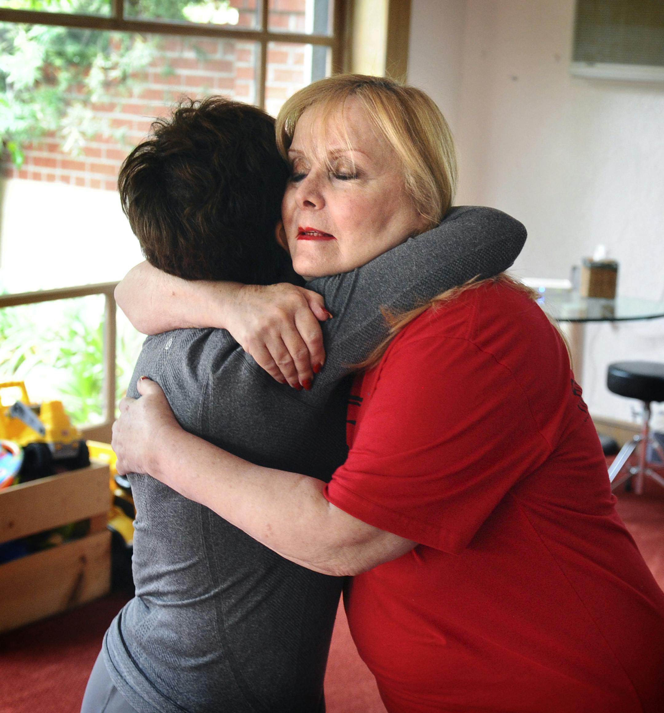 Judi Kaufman gets a hug from her friend Debra Saidoff on Jan. 13, 2015 after a yoga class at her home in Beverly Hills, Calif. Kaufman started writing poetry when a brain tumor made it hard for her to work, and her cancer is no longer treatable. (Wally Skalij/Los Angeles Times/TNS) ORG XMIT: 1162614