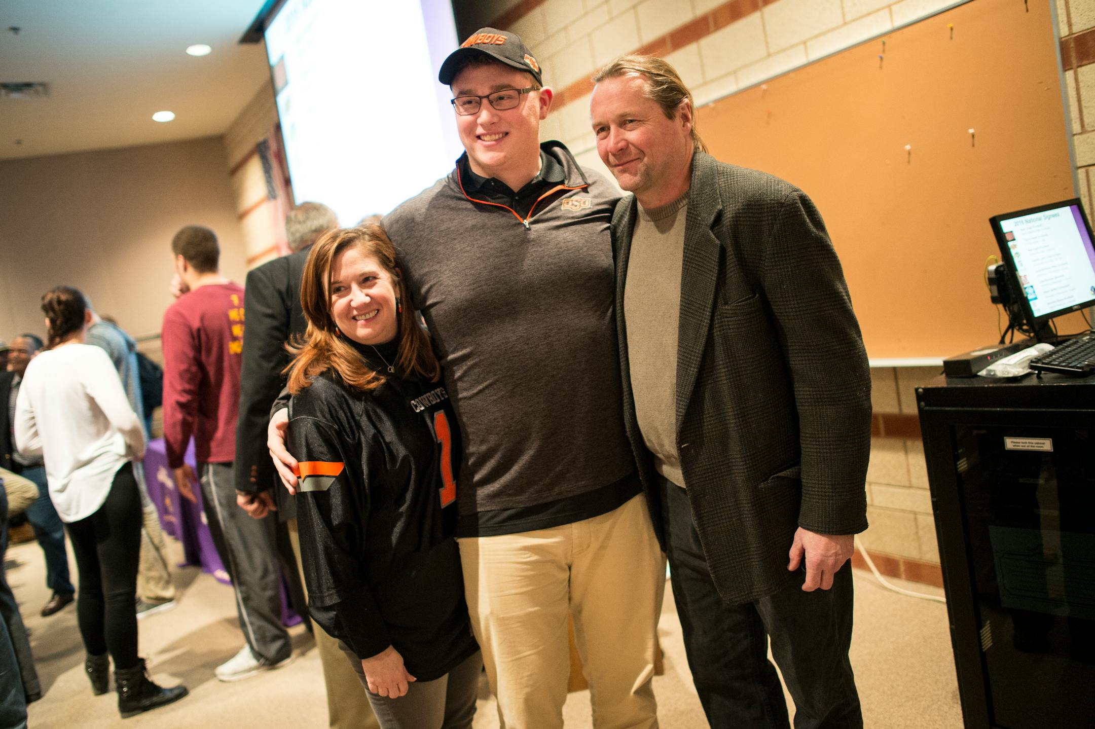 Matt Kegel, center, took photos with his parents Leslie and Matt Kegel after signing a letter of intent to play football for Oklahoma State (Aaron Lavinsky, Star Tribune)