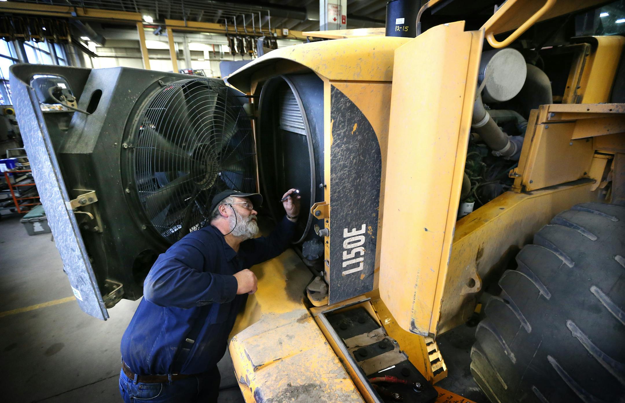 Dale Cannon inspected the radiator of pieces of heavy equipment at the City of Minneapolis fleet services Thursday December 24, 2015 in Minneapolis, MN. ] Jerry Holt/ Jerry.Holt@Startribune.com
