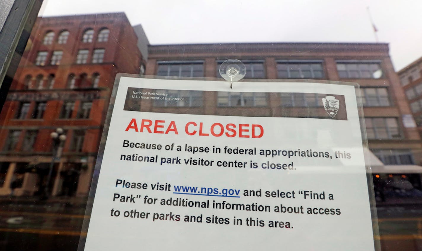 The tiny Klondike Gold Rush National Historical Park in Seattle's historic Pioneer Square neighborhood is posted with a closed sign as part of the federal government shutdown Wednesday, Dec. 26, 2018. The shutdown started Saturday when funding lapsed for nine Cabinet-level departments and dozens of agencies. (AP Photo/Elaine Thompson)