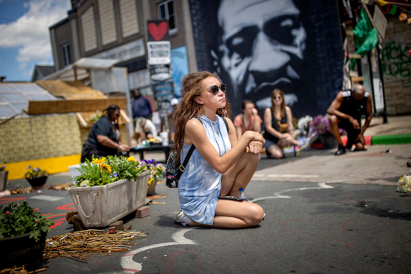 Alivia Boddie, cq, of Albertville, MN joined others as they took a knee for nine minutes at the site where George Floyd was killed during a George Floyd Global Memorial, Tuesday, May 25, 2021 in Minneapolis, MN. ] ELIZABETH FLORES • liz.flores@startribune.com