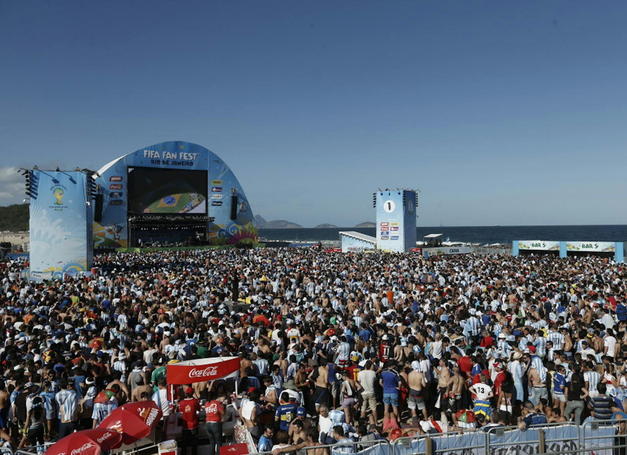 Soccer fans gather to watch the final World Cup match between Argentina and Germany on a giant screen on Copacabana beach in Rio de Janeiro, Brazil, Sunday, July 13, 2014. (AP Photo/Silvia Izquierdo)