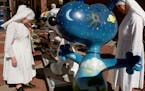 A group of nuns looked at Snoopy statues in downtown St. Paul in 2000.