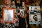 The family of Tekle Sundberg, who was killed by Minneapolis Police, holds photos of him inside the Ramsey County Courthouse in St. Paul on Thursday, N