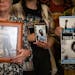 The family of Tekle Sundberg, who was killed by Minneapolis Police, holds photos of him inside the Ramsey County Courthouse in St. Paul on Thursday, N