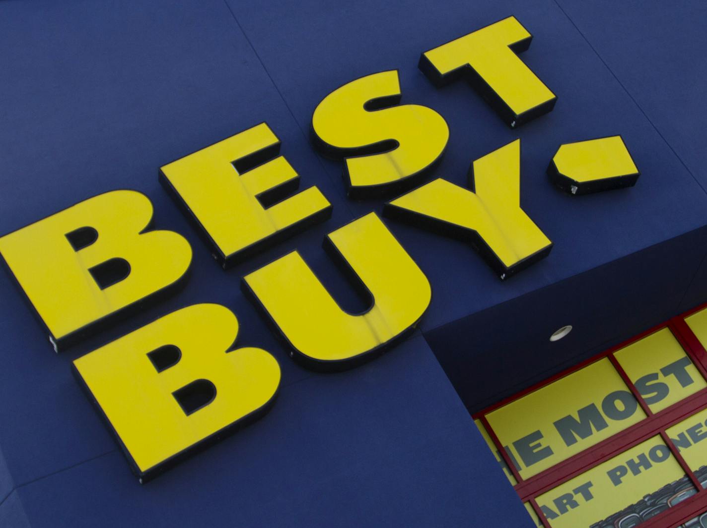 FILE - This undated file photo displays a Best Buy sign on a store in Miami, Fla. Best Buy&#xed;s shares sank Thursday, Jan. 14, 2016, after the nation&#xed;s largest consumer electronics chain reduced its sales outlook for the fourth-quarter as it reported weak holiday business in mobile phone and personal devices. (AP Photo/J Pat Carter, File)