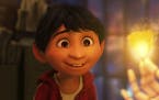 This image released by Disney-Pixar shows characters Miguel, voiced by Anthony Gonzalez in a scene from the animated film, "Coco." (Disney-Pixar via A