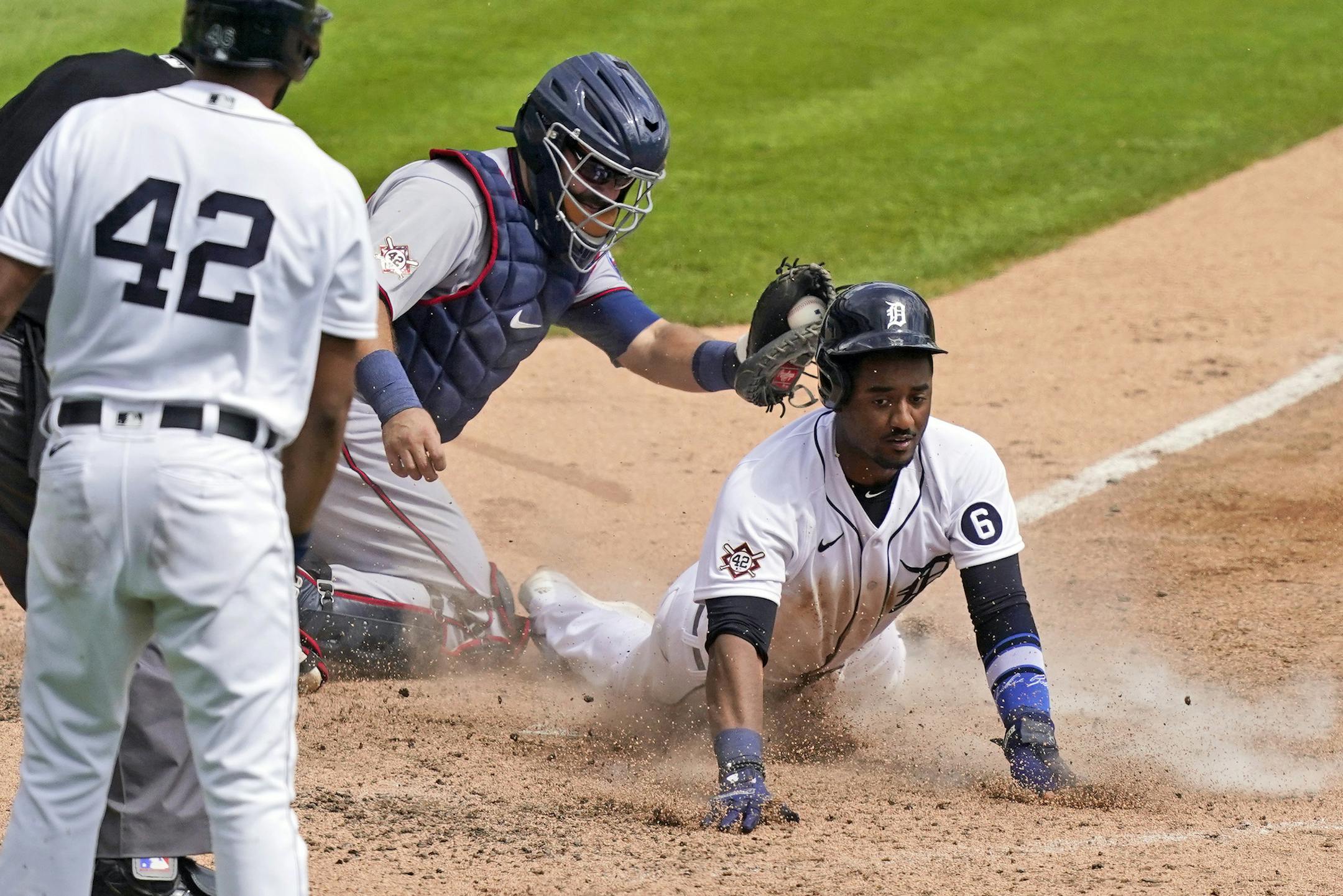 Detroit Tigers' Niko Goodrum beats the tag of Minnesota Twins catcher Alex Avila to score during the fifth inning of the first baseball game of a doubleheader, Saturday, Aug. 29, 2020, in Detroit. (AP Photo/Carlos Osorio)