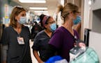 Registered nurse Kristina Shannon, chaplain Andrea Cammarota and ER charge nurse Cathy Carter watched as medical workers tried to resuscitate a patien