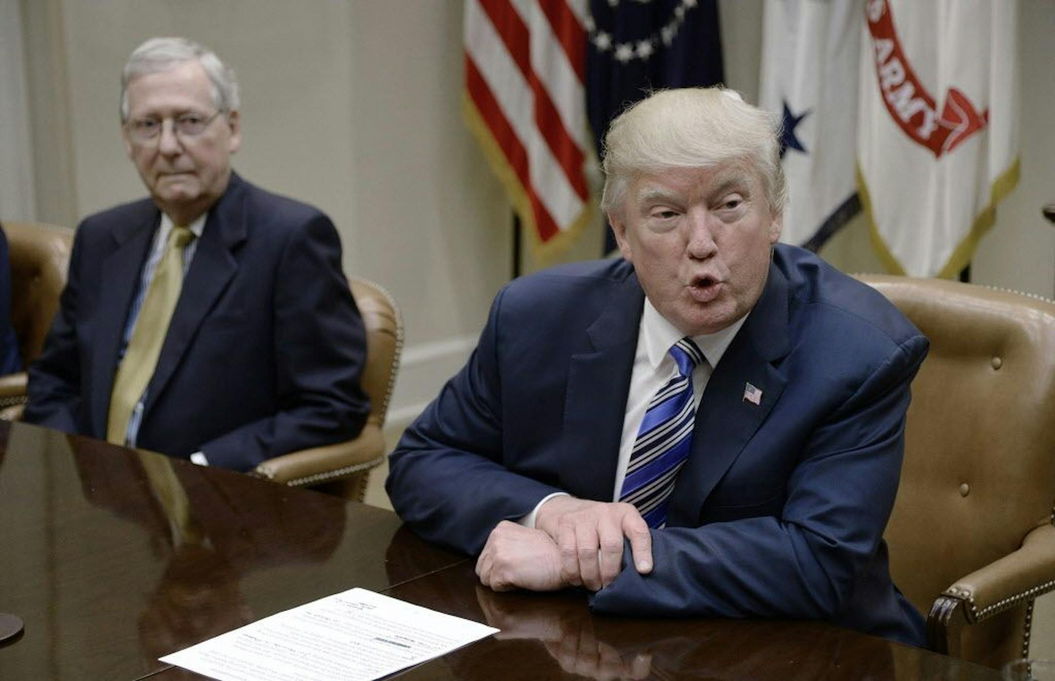 FILE -- President Donald Trump spoke as Senate Majority Leader Mitch McConnell, left, looked on during a meeting with House and Senate leadership on June 6, 2017, in the Roosevelt Room of the White House in Washington, D.C.