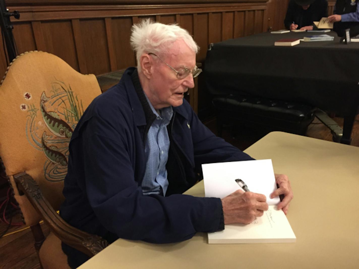 Robert Bly autographs books on Monday night.