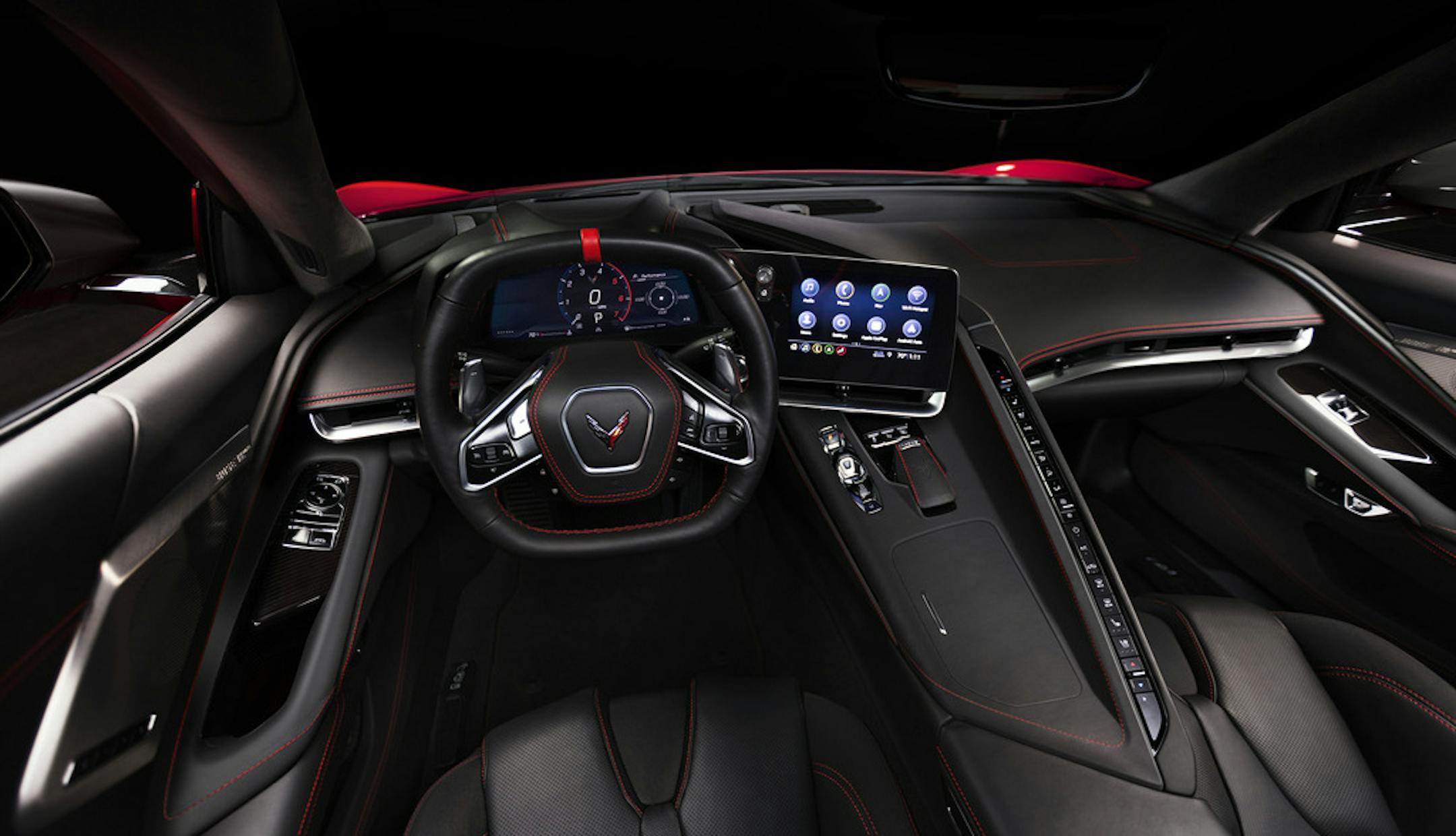 The interior of the 2020 Chevrolet Corvette C8 Stingray. Note the large screens and long wall of buttons on the center console.