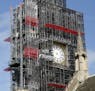 Scaffolding surrounds the hand-less face of the world famous clock on the Queen Elizabeth Tower, which also holds the bell known as Big Ben, as it con