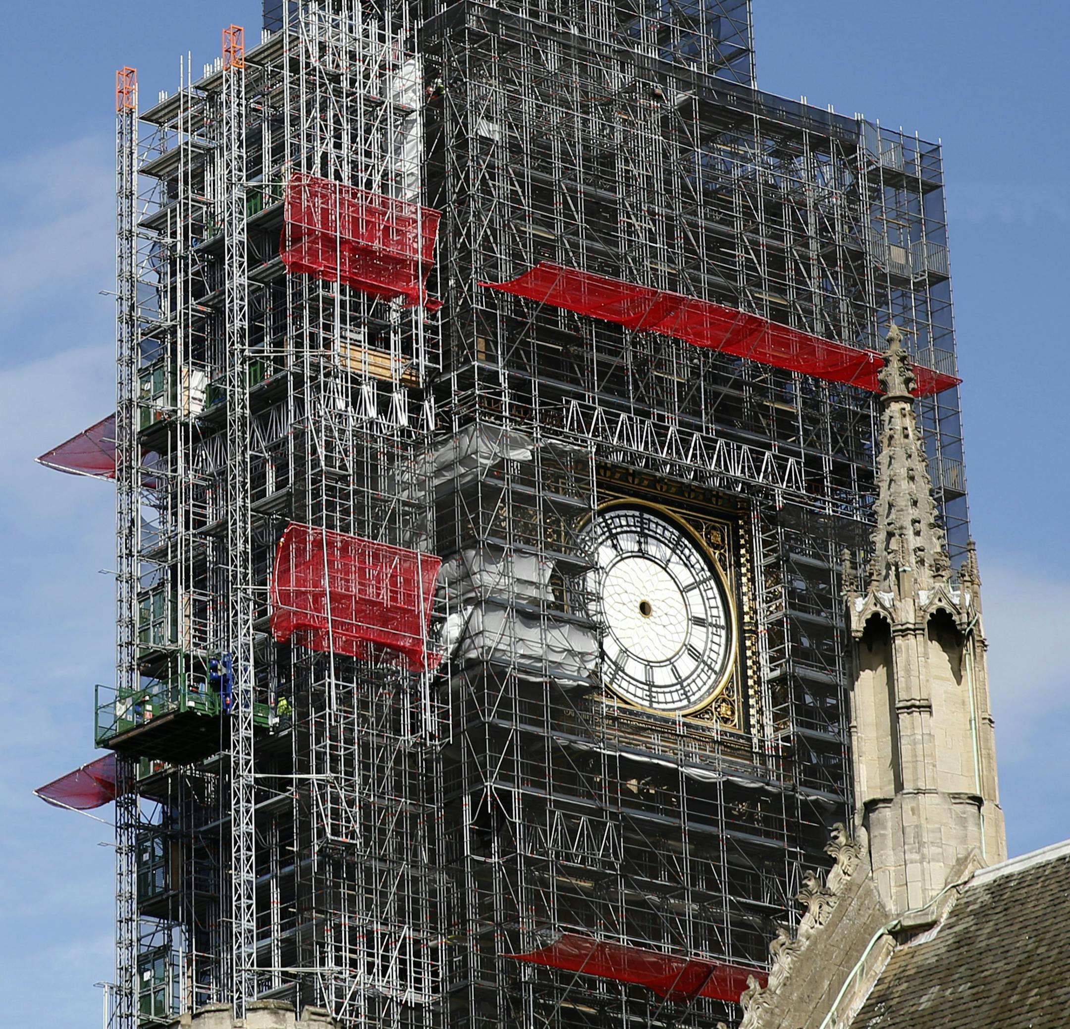Scaffolding surrounds the hand-less face of the world famous clock on the Queen Elizabeth Tower, which also holds the bell known as Big Ben, as it continues to be refurbished as part of the overall 3.5 billion pound repair of the Palace of Westminster, in London, Tuesday, April 17, 2018. The repairs are set to take several years to complete. (AP Photo/Alastair Grant)