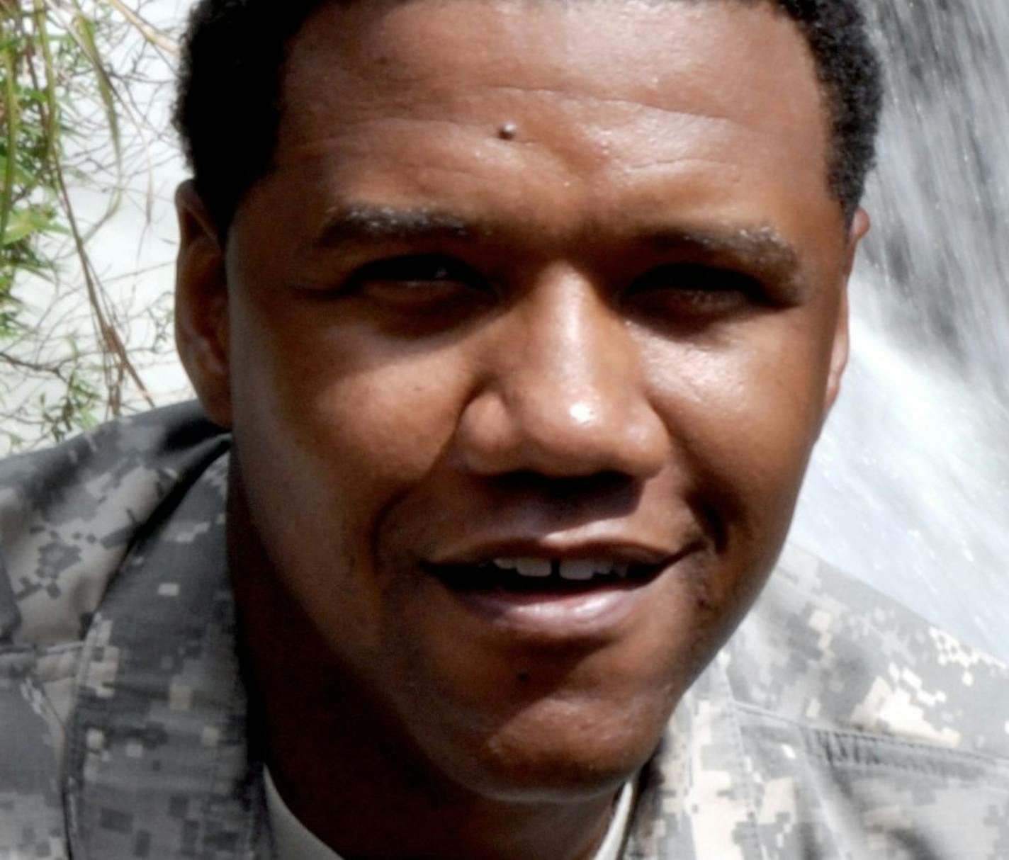 In this June 6, 2015 photo, U.S. Army National Guard Sgt. 1st Class Charleston Hartfield of the 100th Quartermaster Company poses for a photo at Rainbow Falls near Hilo, Hawaii. Hartfield was one of the people killed in Las Vegas after a gunman opened fire on Sunday, Oct. 1, 2017, at a country music festival. (Sgt. Walter Lowell/U.S. Army National Guard via AP)