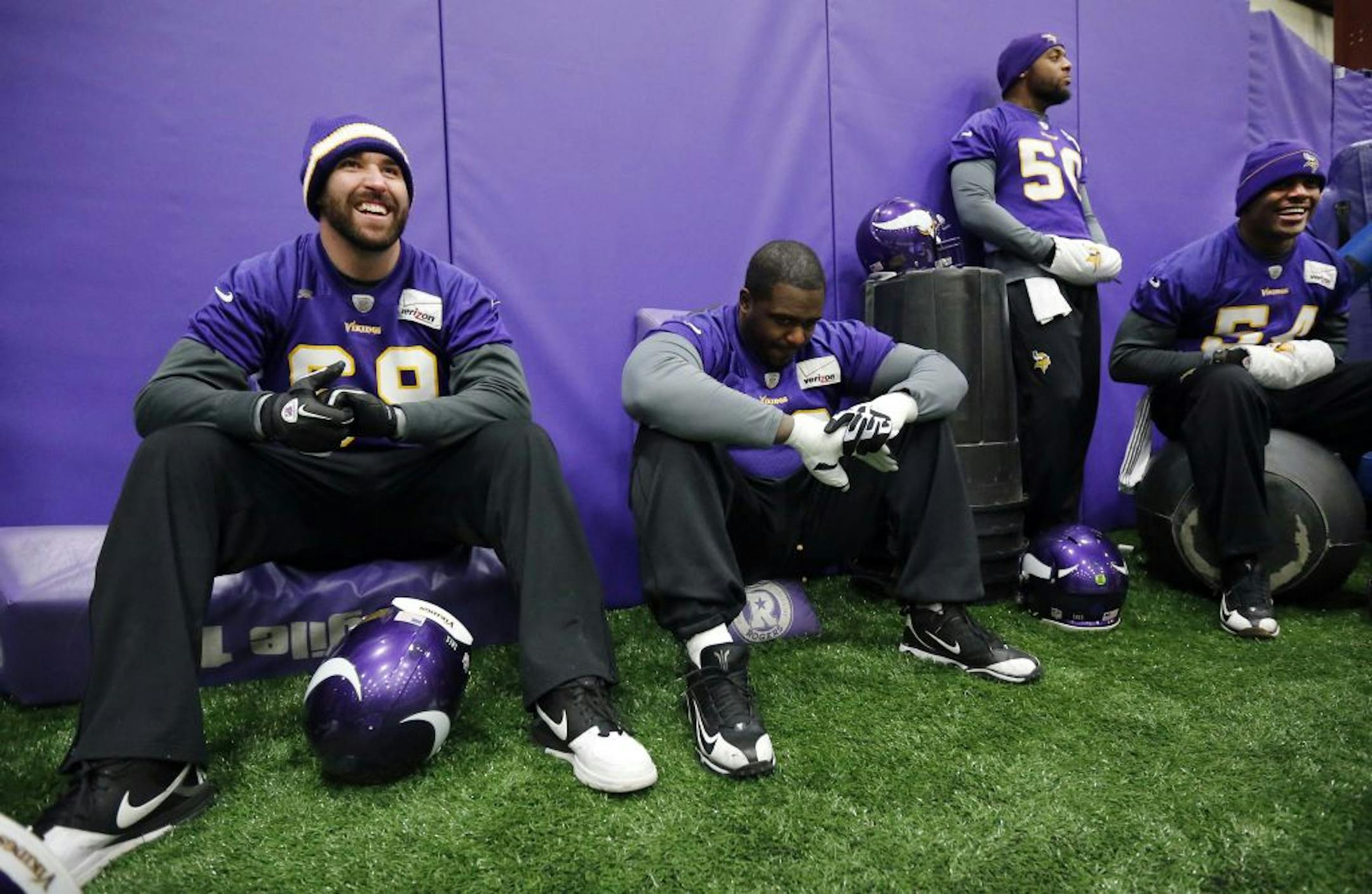 Vikings Jared Allen (69), Fred Evans (90), Erin Henderson (50) and Jasper Brinkley (54) joked during the special teams portion of practice Thursday.