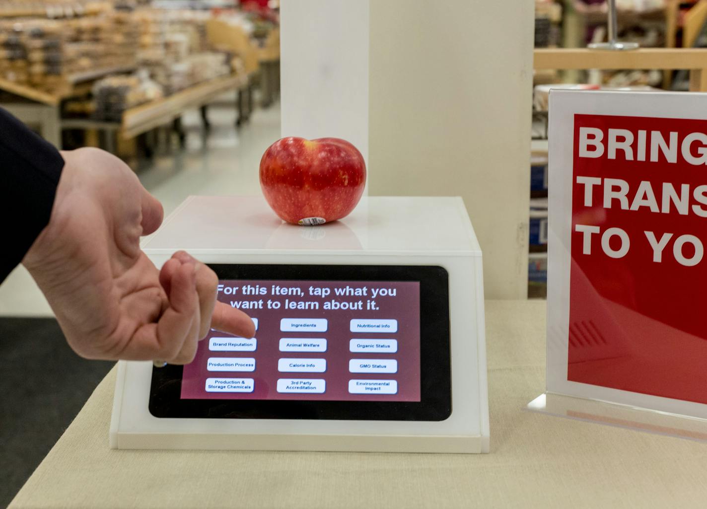 Target Executive Greg Shewmaker demonstrates the new food scanner that tells costumers an array of things including how ongrangic the product is and how many GMOs are in the food at the Edina Target off of York Ave, Friday afternoon. ] Elizabeth Brumley special to the Star Tribune * Target is toying around with some new food ideas at its lab in Boston.