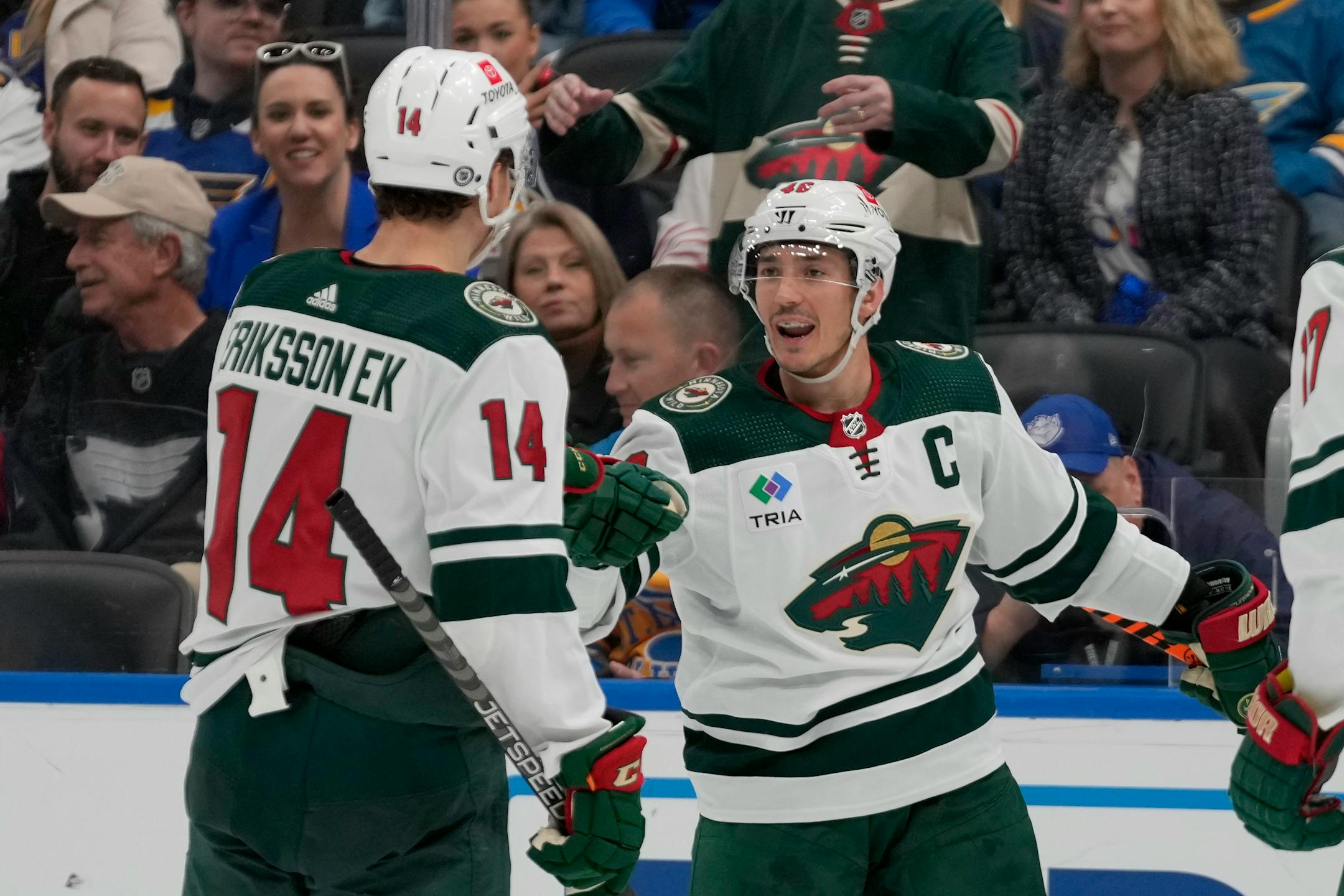 Minnesota Wild's Jared Spurgeon is congratulated by Joel Eriksson Ek (14) after scoring during the third period of an NHL hockey game against the St. Louis Blues Saturday, Dec. 31, 2022, in St. Louis. (AP Photo/Jeff Roberson)