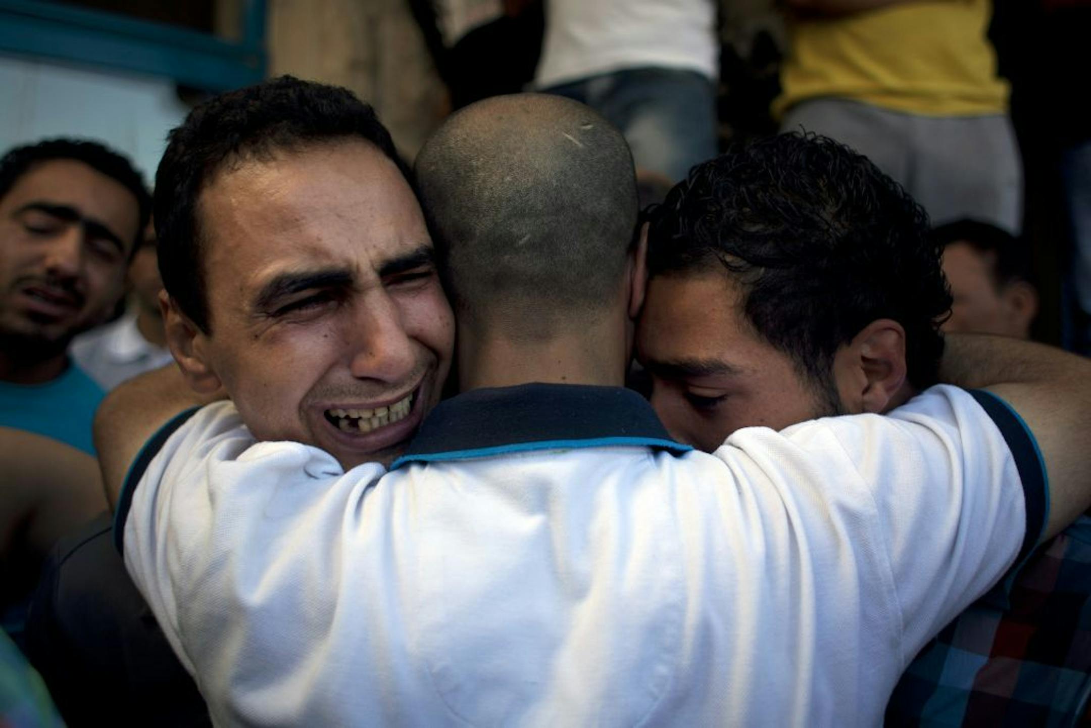 Palestinian mourners grieve while waiting for the funeral procession outside the morgue of the main hospital in the West Bank town of Ramallah, Monday, Aug. 26, 2013. Israeli soldiers killed three Palestinians in clashes during an arrest raid in the West Bank.