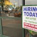 A sign that reads "hiring today," is shown at a grocery store in Olympia, Wash., advertising a job opportunity for a meat cutter on Oct. 3, 2020. On T