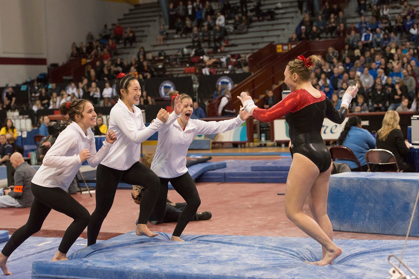 Stillwater's Isabel Bartosh sticks her landing off the uneven parallel bars during the Class 2A Gymnastics state meet.