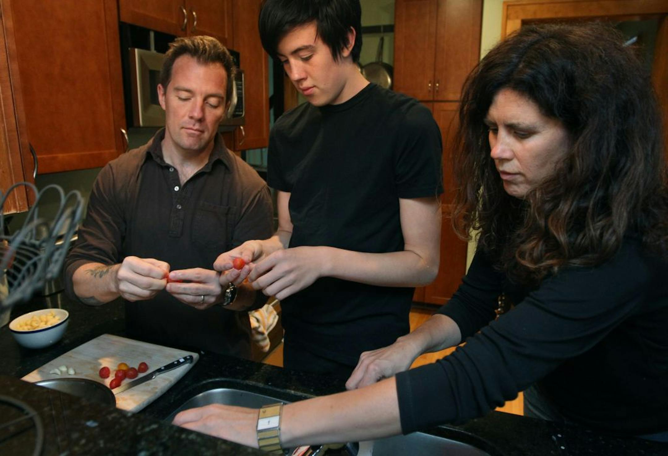 Isaac Becker, and Nancy St. Pierre cook with their two boys, Klaus Becker, eldest and Winston at their home in south Minneapolis. Klaus and Isaac peel the tomato. while nancy clean a knife. Taste cover on chefs with kids cooking for their families. Will include Isaac Becker, who owns Bar La Grassa and 112 Eatery and soon to be completed Burch with wife Nancy, who runs front of restaurant. Plus Alex Roberts of Brasa and Restaurant Alma plus Michelle Gayer of Salty Tart. [ TOM WALLACE • twallace@s